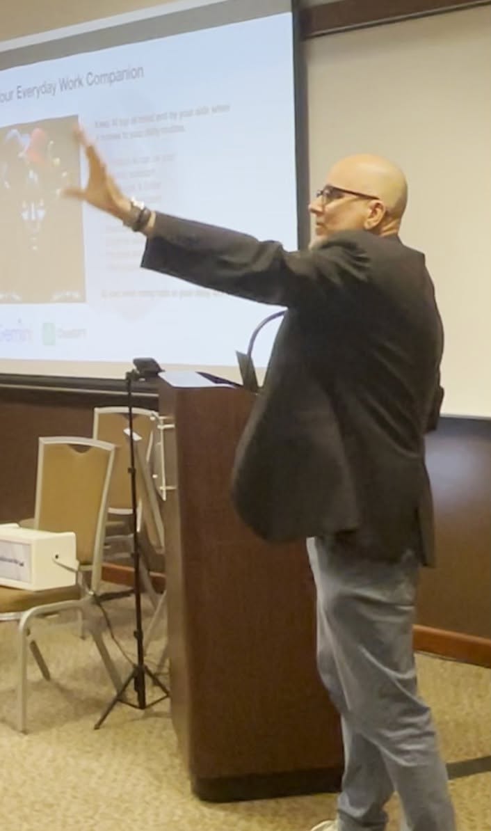Tommy Onyx gesturing toward the audience during his presentation