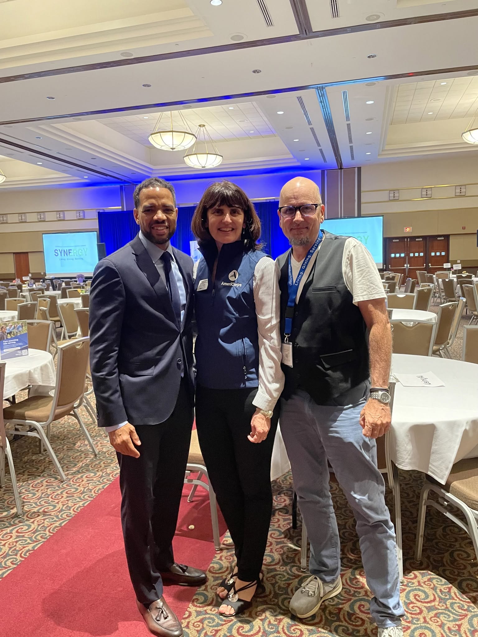 Mike Ellison, Ginna Holmes, and Tommy Onyx at the 2024 Synergy Conference, from left to right